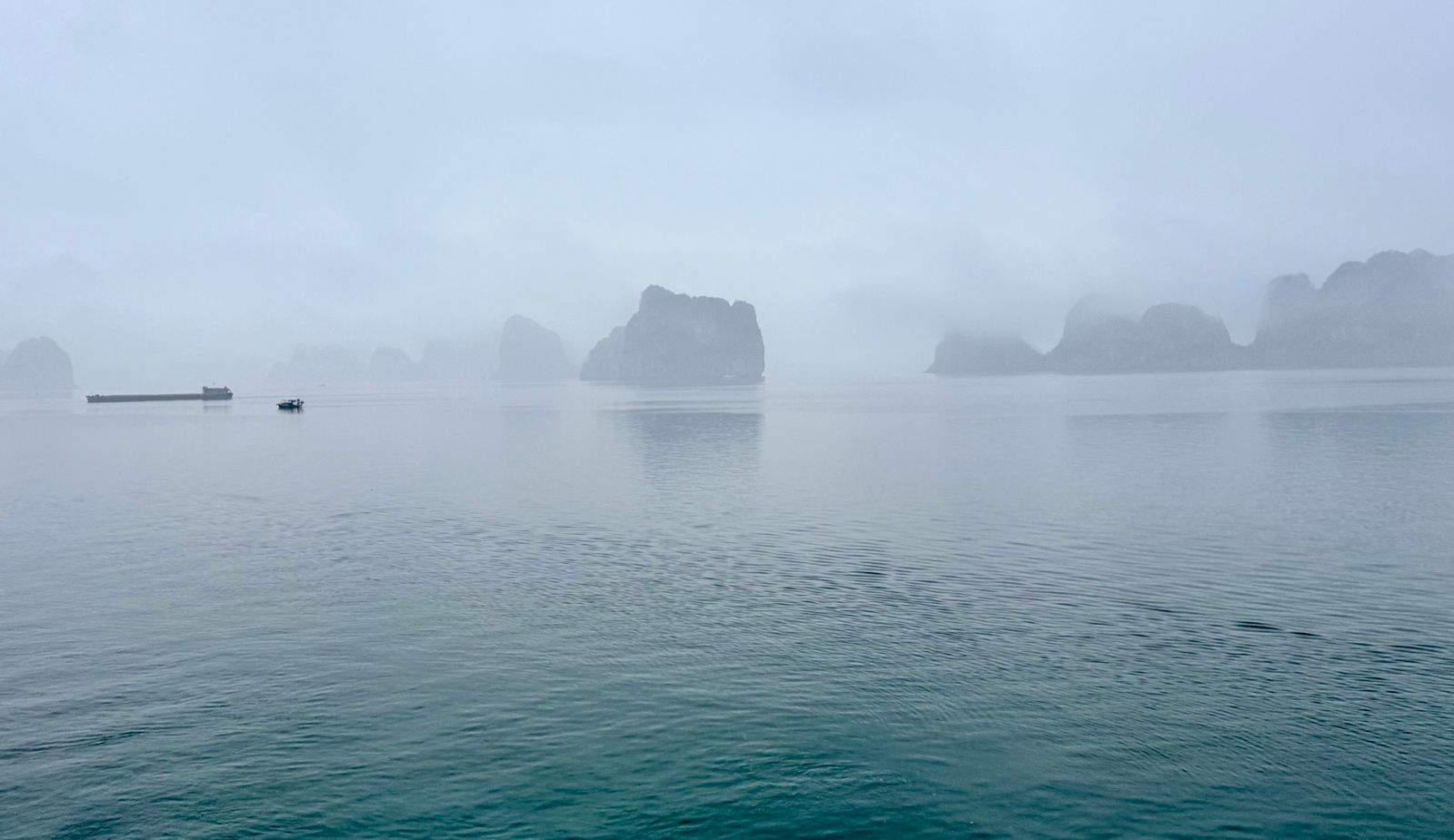 Misty morning over Halong Bay's karst formations