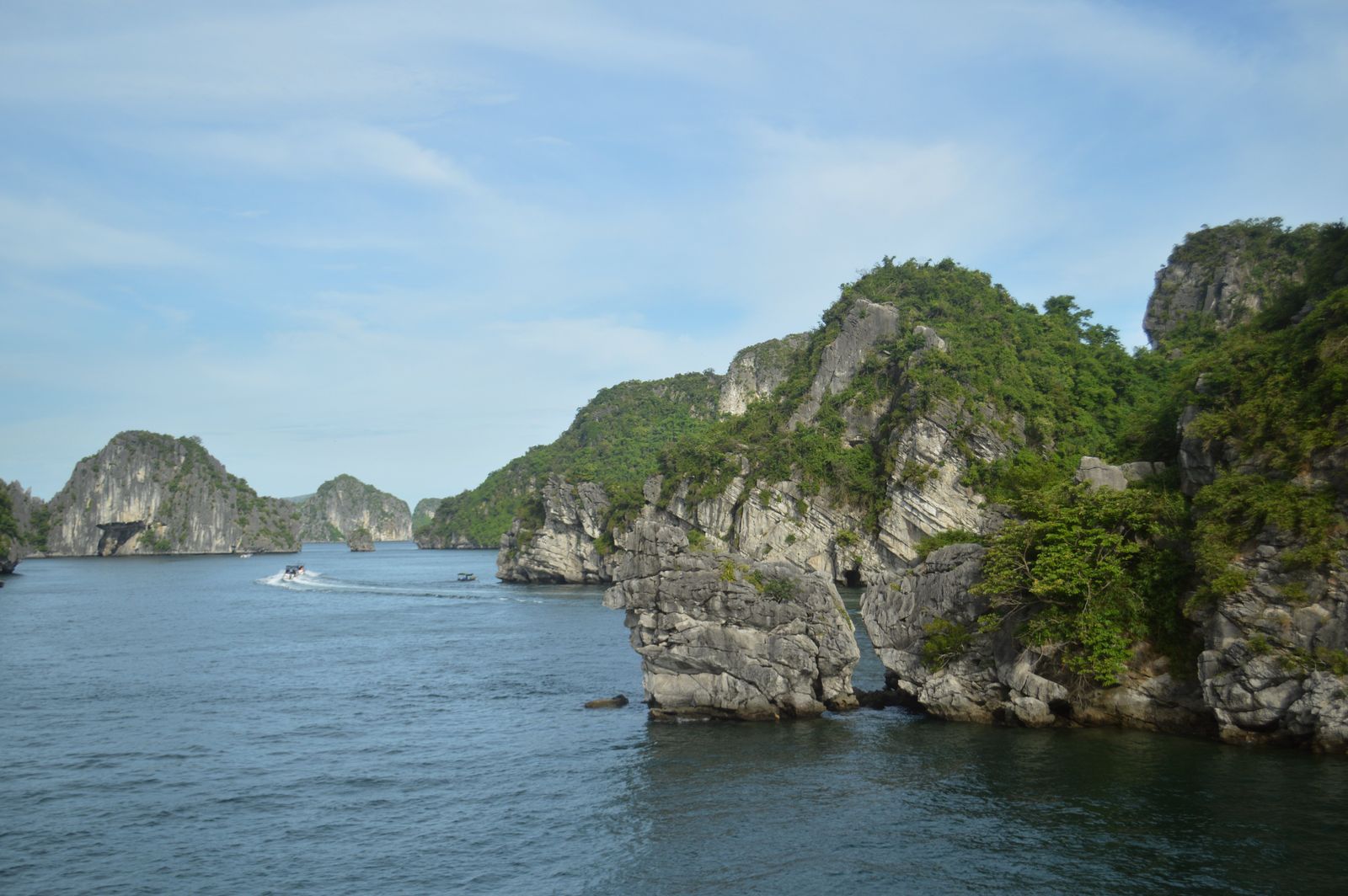 Limestone formations and calm water in Halong Bay